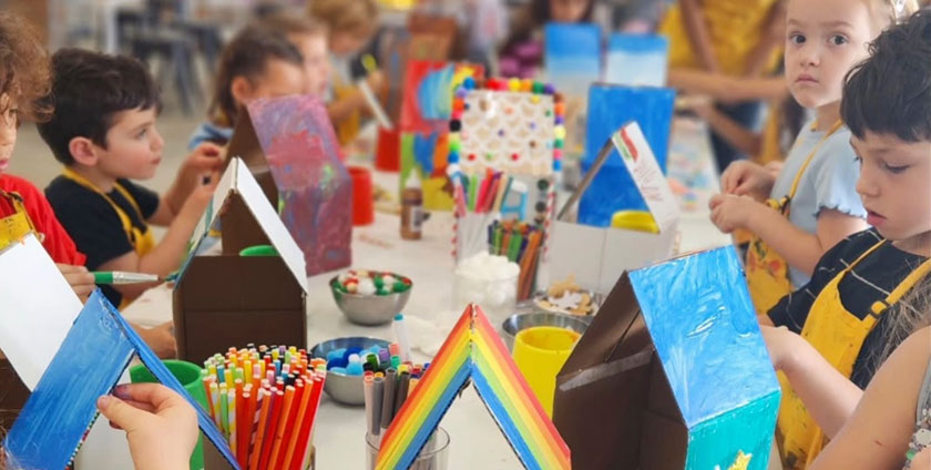 Kids creating art projects during camp at The Poppet Project