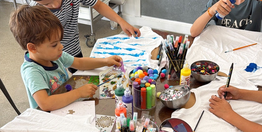 Child participating in a creative art class at The Poppet Project