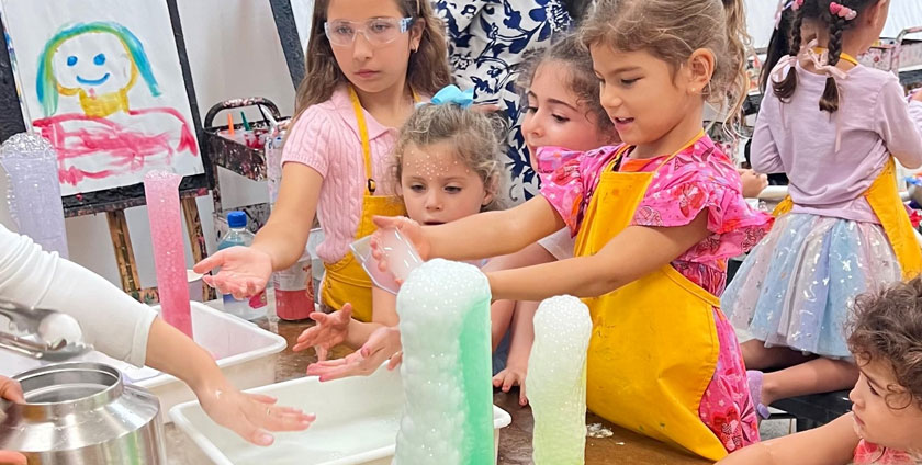 Kids exploring art and science activities during Open Studio
